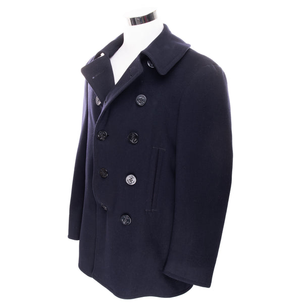 Vintage Usn Us Navy Peacoat WW2 Size 40

These double breasted coats continued to be made of a smooth 100% wool outer shell with a rayon type inner lining. There were eight buttons showing on the front of the coat with small buttons under the collars, and an attached throat latch so the coat could be tightly buttoned at the throat. There was one row of stitching approximately 3" above the cuff, which also had a single row of stitching just above the cuff. The hand warmer pockets were lined with tan or light