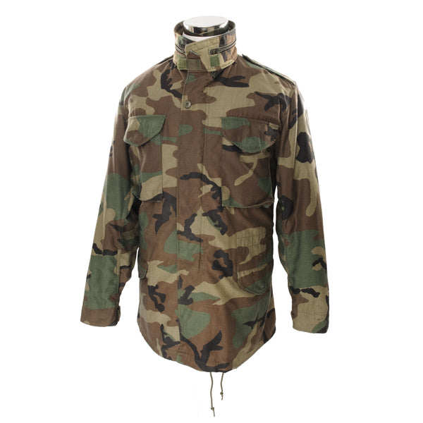 Vintage US Army M-1965 M65 Woodland Camouflage Pattern Field Jacket 1989 Size Small Long  STOCK NO. 8415-01-099-7832  DLA 100-89-C-0436  The M-65 field jacket was widely used by United States forces during the Vietnam War and became a classic used by the U.S. troops in several other wars all around the world. 