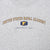 Close-up of United States Naval Academy Annapolis, MD chest print with blue and gold N emblem