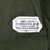 Spec label for OG-107 cotton sateen utility shirt with DSA100-76-C-1480 contract number