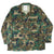 Front view of USMC woodland hot weather coat with four flap pockets and USMC stencil