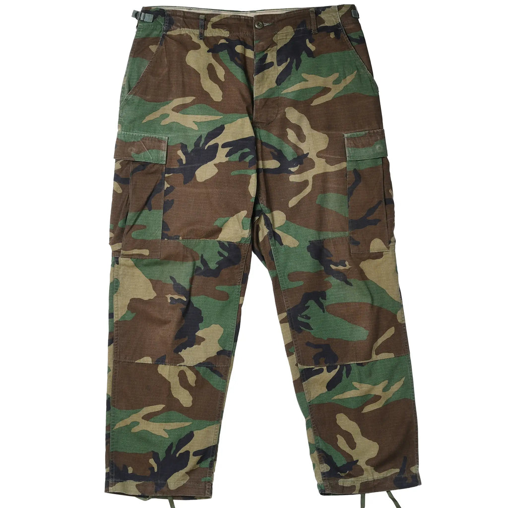 Front view of US Army ripstop woodland camo combat trousers with cargo pockets