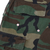Close-up of woodland camo cargo pocket flap and stitching on US Army combat trousers