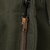 Close-up of metal fly zipper on olive green US Army M51 field wool trousers
