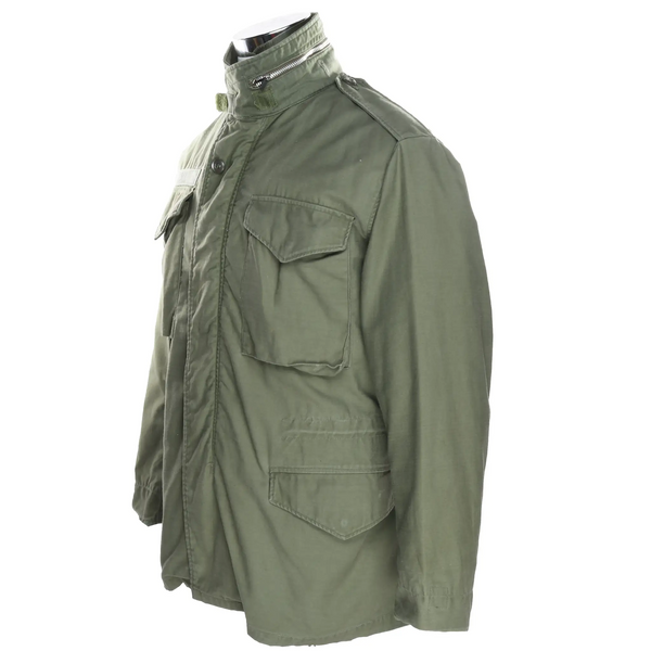 Three-quarter side view of olive green US Army M65 field jacket with flap pockets