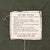 Interior care and use label for Coat, Man's, Field, M-65 stitched to olive green fabric