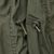 Close-up of M65 field jacket drawcord ends threaded through metal eyelets