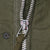 Close-up of M65 field jacket front metal zipper, pull tab and snap fastener