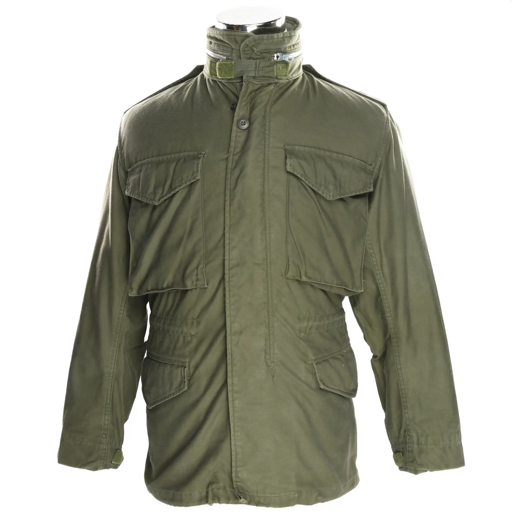 Front view of olive green US Army M65 field jacket with four flap pockets and stand collar
