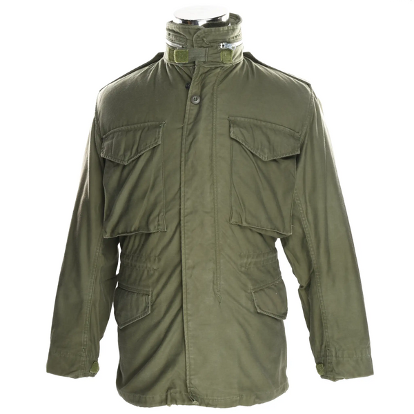 Front view of olive green US Army M65 field jacket with four flap pockets and stand collar