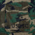 Close-up of chest pocket with USMC stencil on woodland camouflage fabric