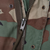 Close-up of the M65 Woodland camo jacket's front zipper and snap fasteners