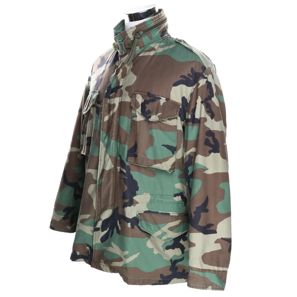 Three-quarter front view of US Army M65 Woodland camo field jacket with four flap pockets