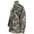 Angled front and side view of US Army M65 field jacket in woodland camo with flap pockets and stand collar.