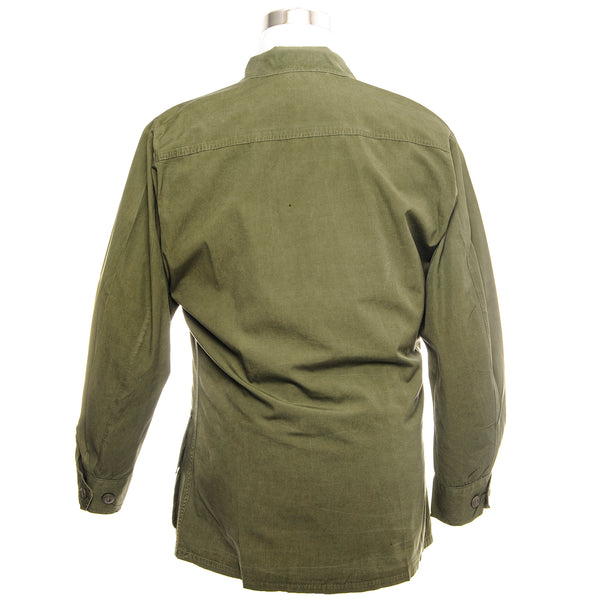 The 3rd major version of the Tropical Combat Coat was first produced in 1966 and had no gas flap, epaulets, waist tabs or pocket drain holes. It was the first jungle jacket to have a back yoke and was made in both OG-107 and ERDL camouflage. Like all prior models it was made from wind-resistant cotton poplin and had pen pockets behind both chest cargo pockets.