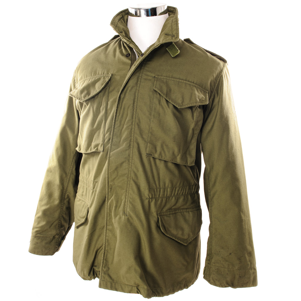 The M-65 field jacket was widely used by United States forces during the Vietnam War and became a classic used by the U.S. troops in several other wars all around the world.   The M-1965 jacket was initially designed by Alpha Industries and was made from OG-107 (Olive Green Shade 107) water repellent and wind resistant cotton-nylon sateen. The fabrics was made by Burlington Fabrics.