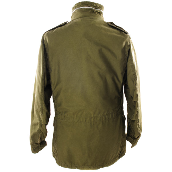 The M-65 field jacket was widely used by United States forces during the Vietnam War and became a classic used by the U.S. troops in several other wars all around the world.   The M-1965 jacket was initially designed by Alpha Industries and was made from OG-107 (Olive Green Shade 107) water repellent and wind resistant cotton-nylon sateen. The fabrics was made by Burlington Fabrics.